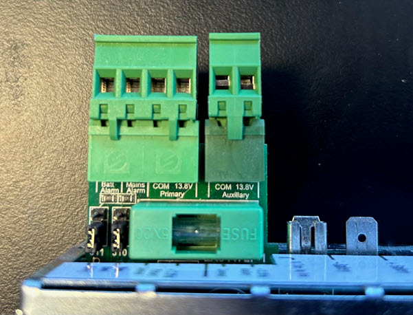Power supply close-up showing the monitoring board output connections
